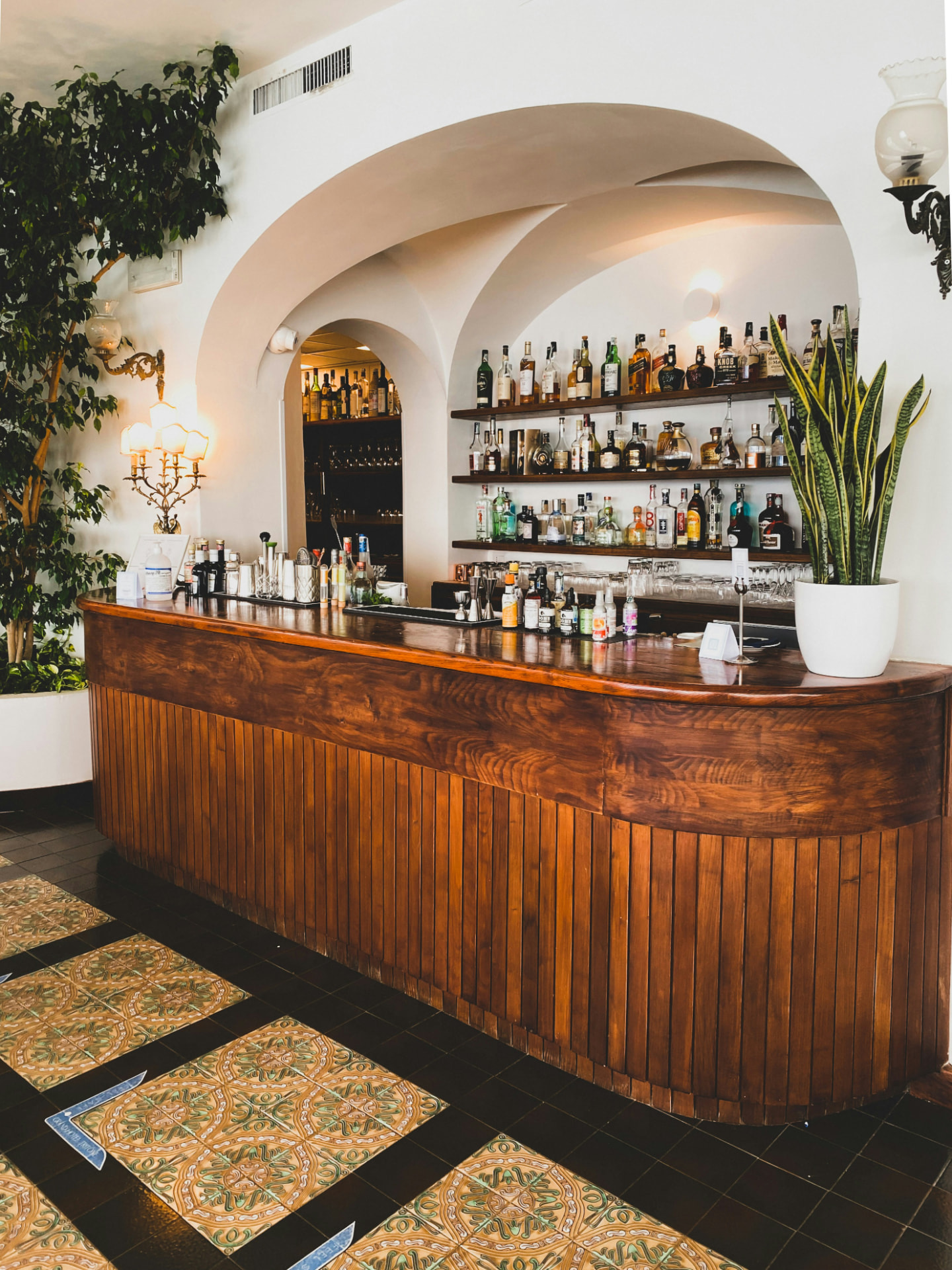 Hand-finished curved walnut bar counter in an upscale hotel bar
