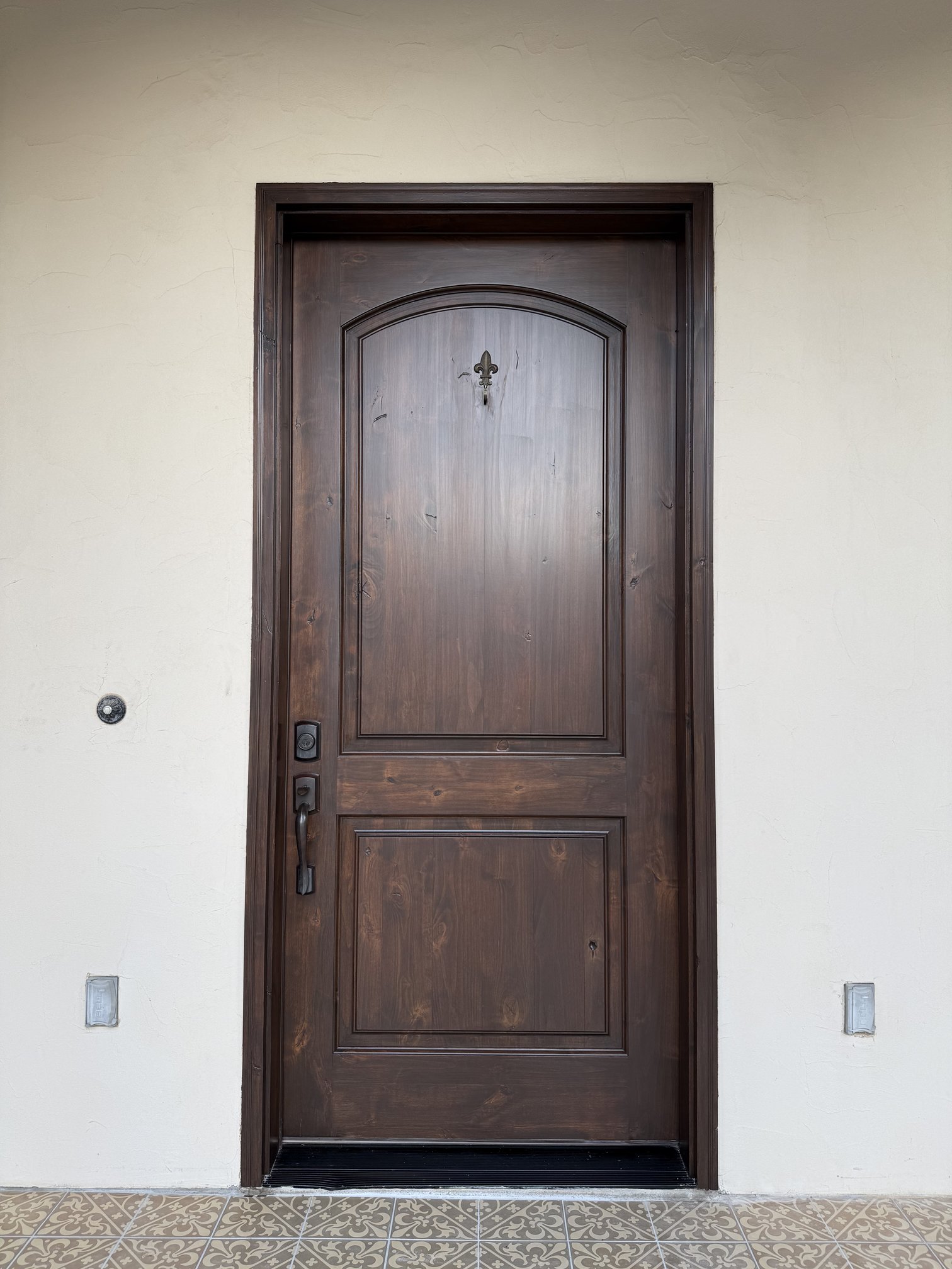 Full view of the refinished dark-brown entry door with restored panels after completion in New Braunfels