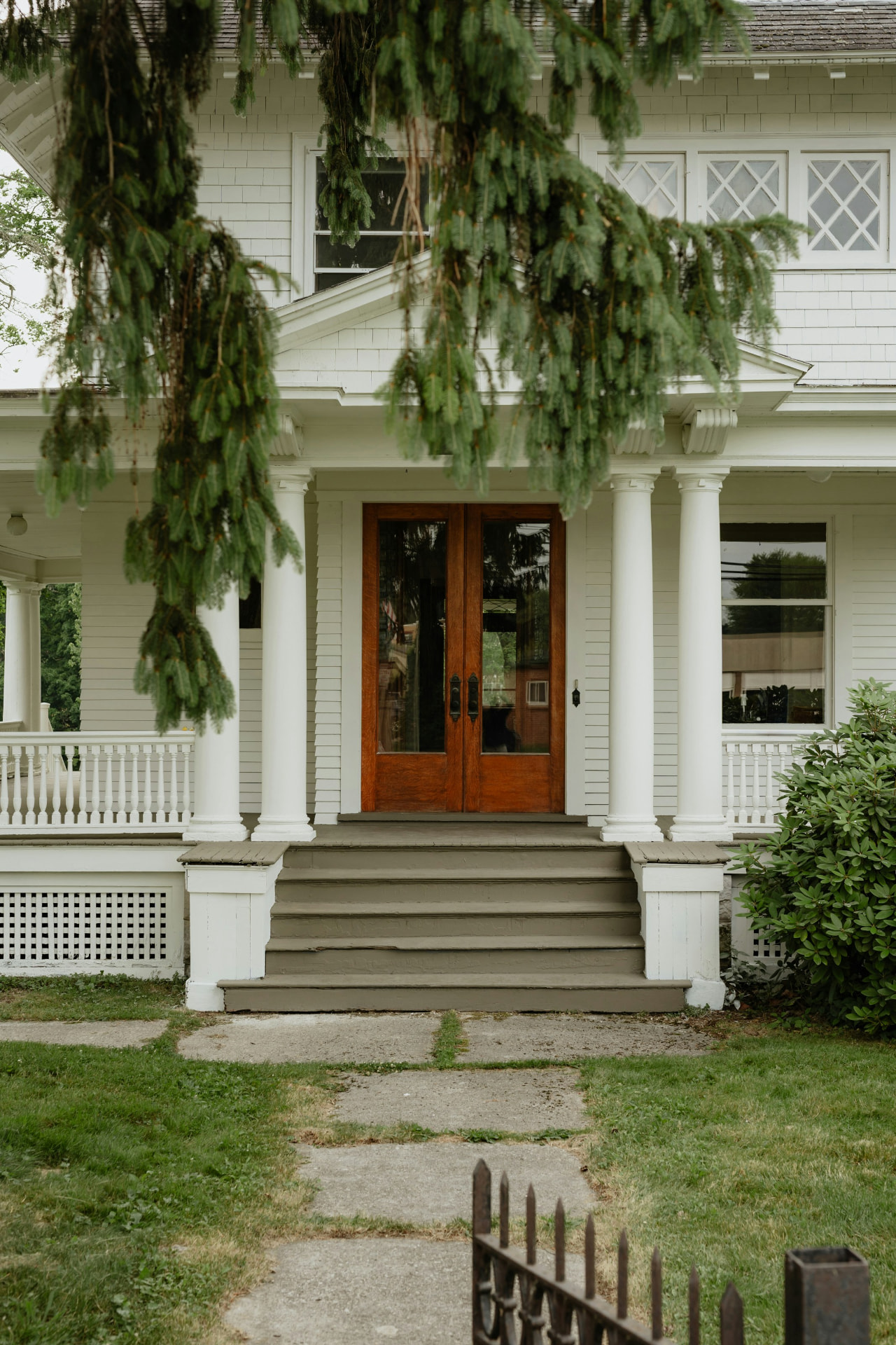 Classic white porch with a restored wood front door