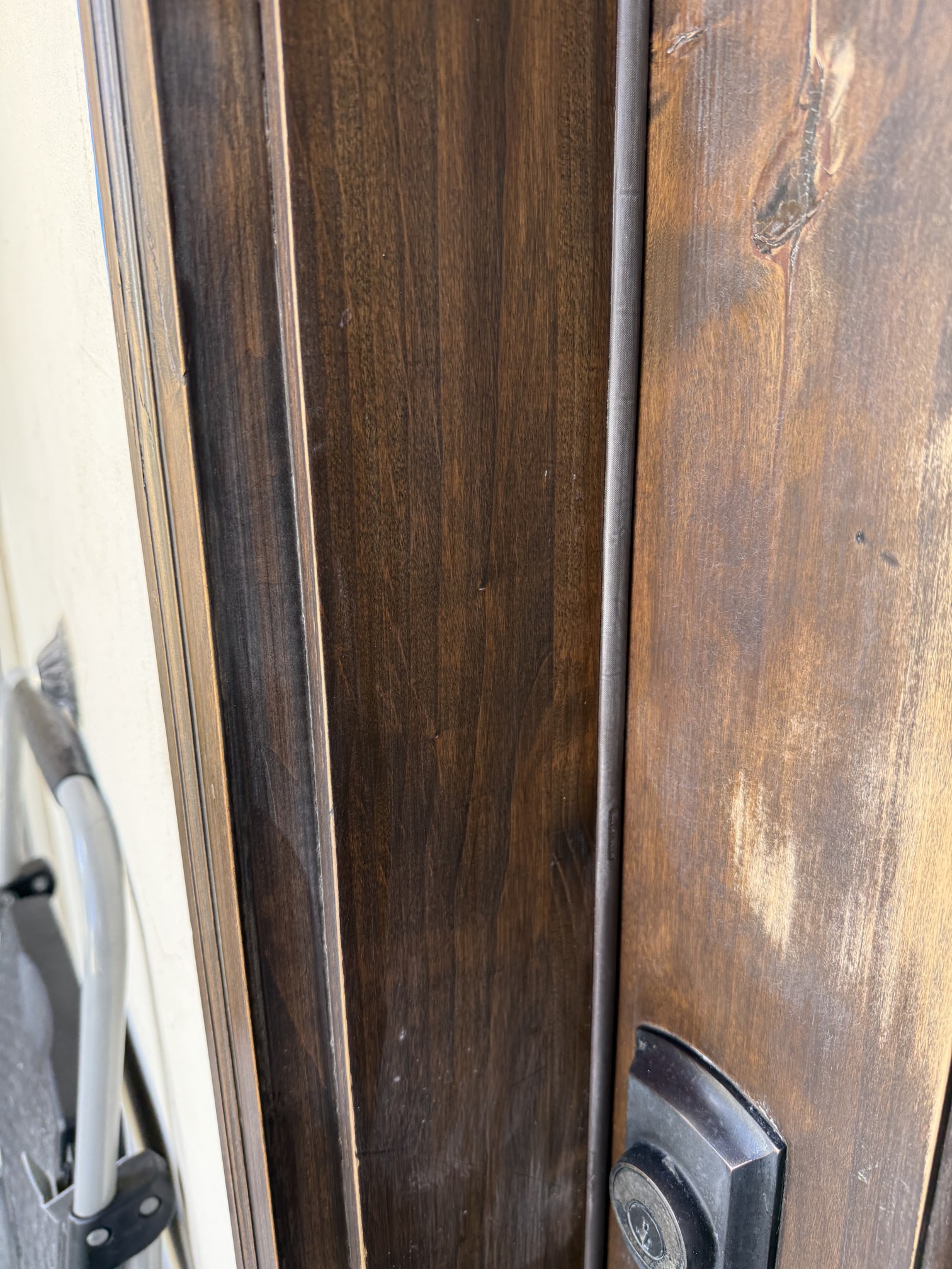 Close-up of the door edge being refinished with filler work and stain blending in progress in New Braunfels