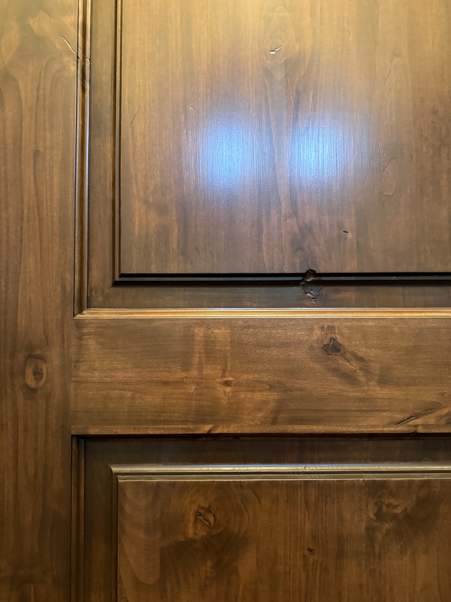 Close-up of the refinished door panels with an even stain and smooth protective topcoat in New Braunfels